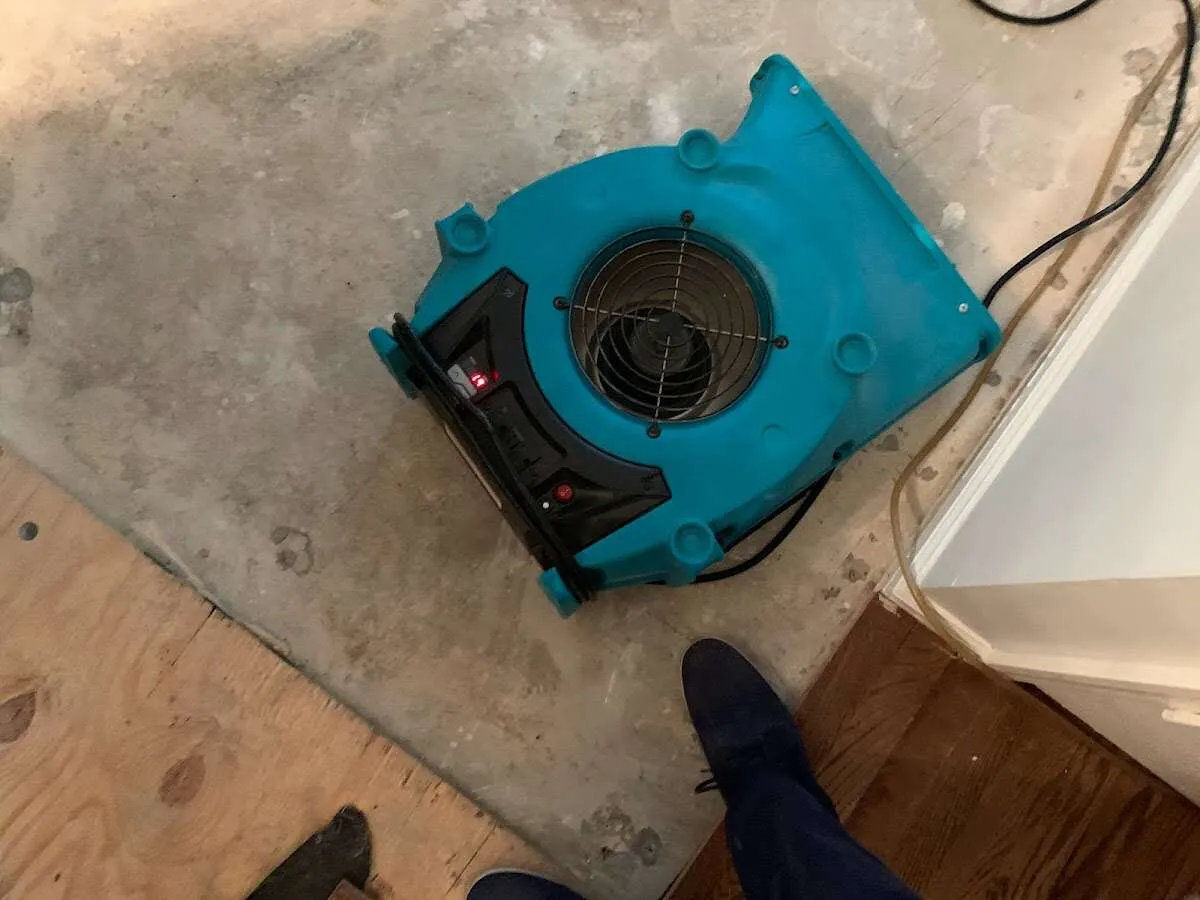 Air mover drying subfloor during Commercial Water Damage Restoration in Horseshoe Bay